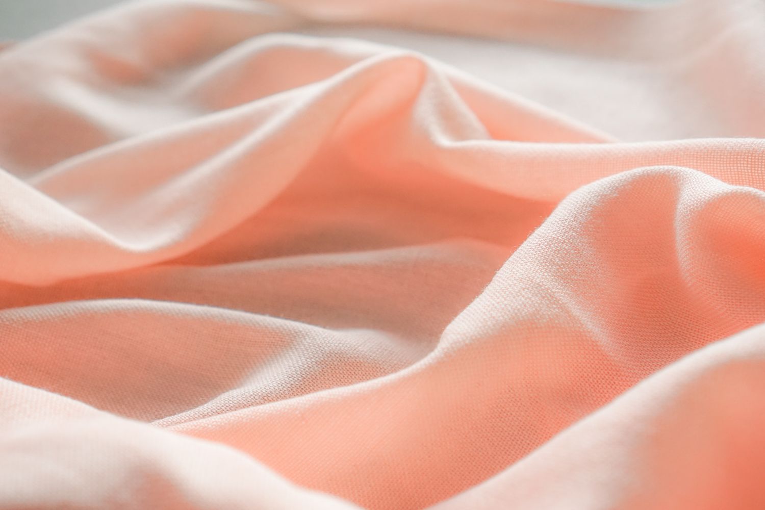 Close-up of soft coral cotton fabric, similar texture and tone to the Blush colourway